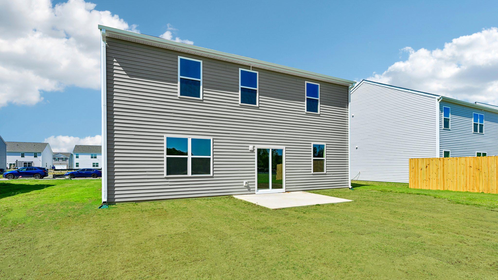 back of home with concrete patio