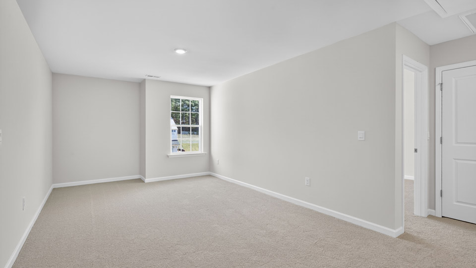 upstairs loft area with large windows and carpeting