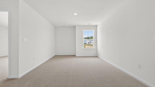 upstairs loft area with large windows and carpeting