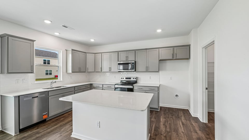 kitchen with island gray cabinets and quartz countertops
