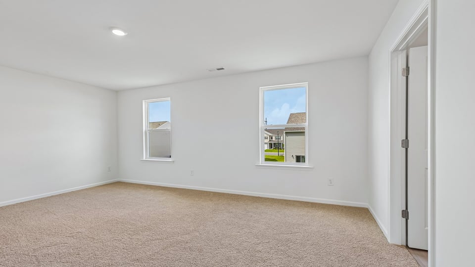 primary bedroom with carpet flooring
