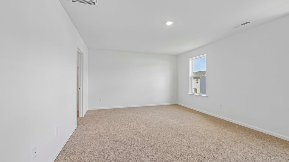 primary bedroom with carpet flooring