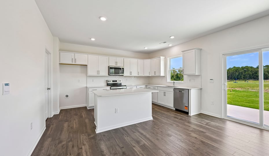 kitchen with white cabinets center island and quartz countertops