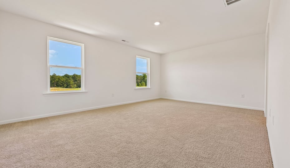 primary bedroom with carpet flooring