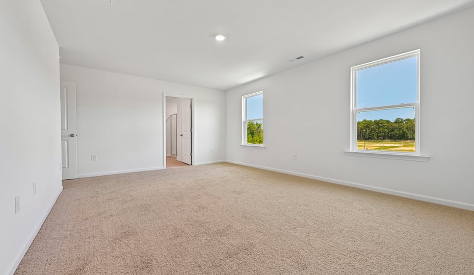 primary bedroom with carpet flooring