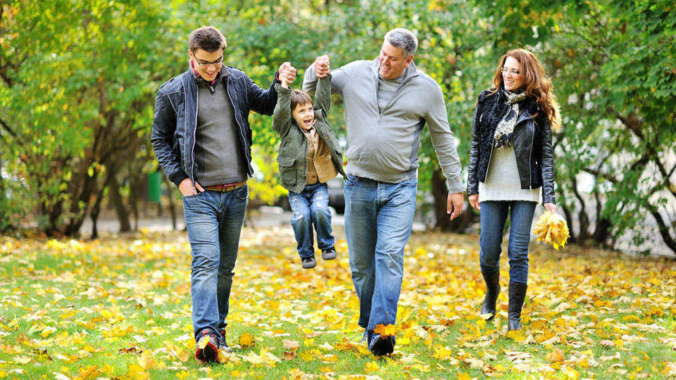 young family walking outside