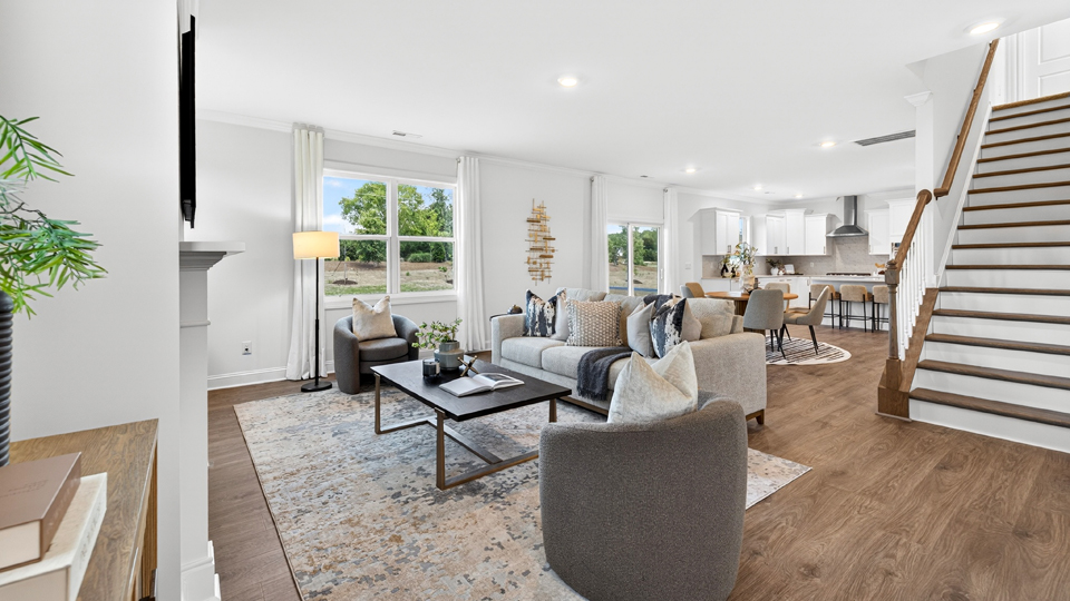open concept living space with large windows, fireplace