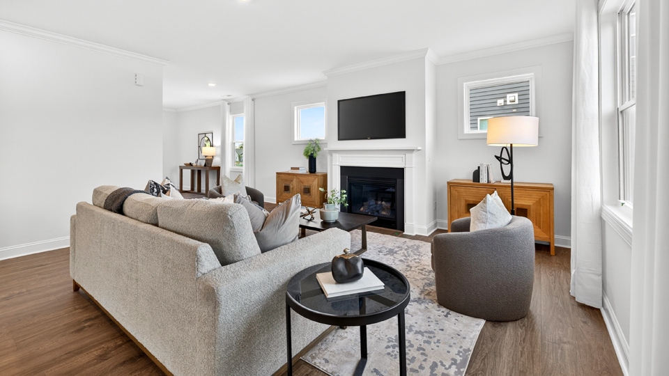open concept living space with large windows, fireplace