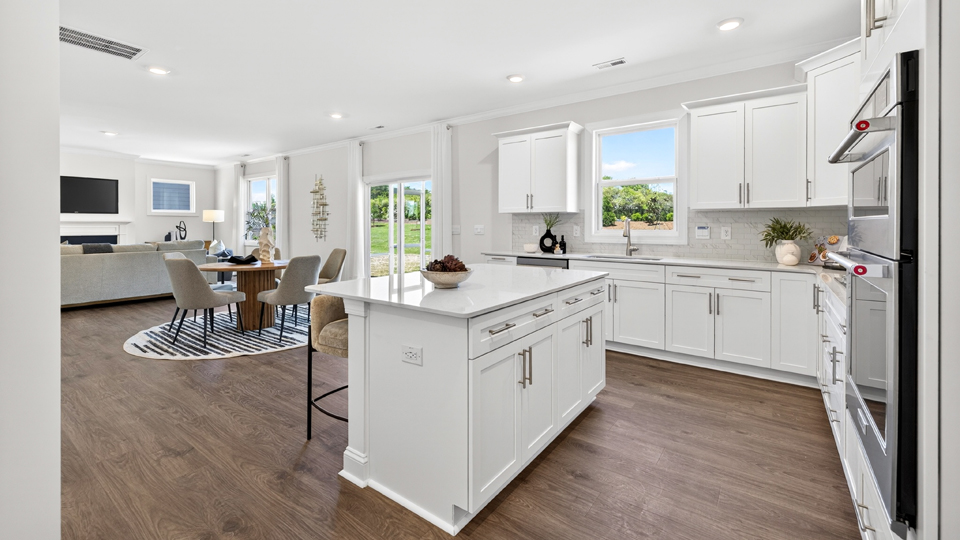 kitchen with quartz counters, kitchen island, pantry, stainless steel appliances