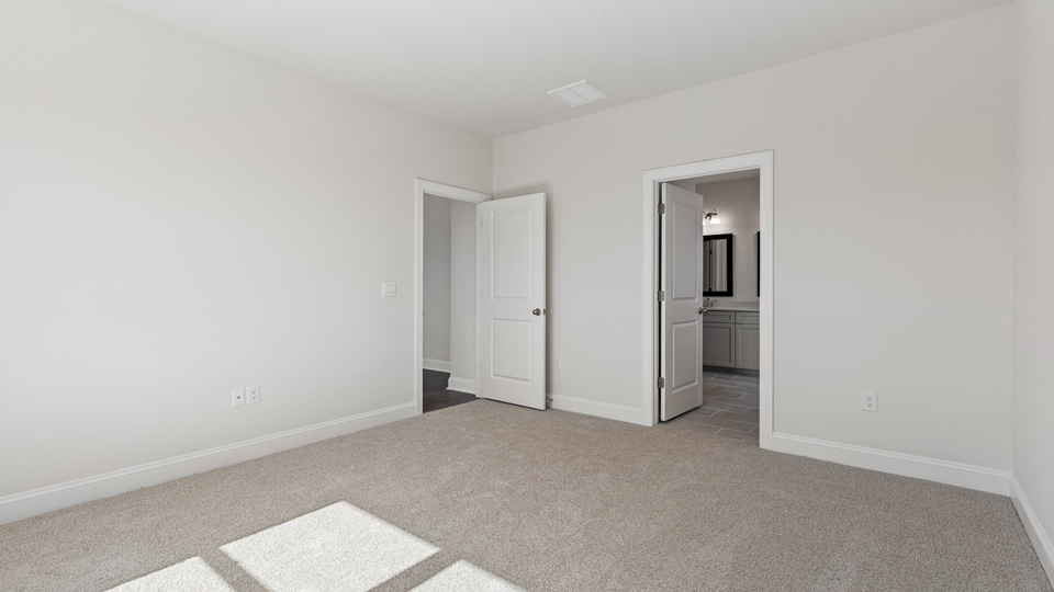 Primary bedroom with carpet flooring