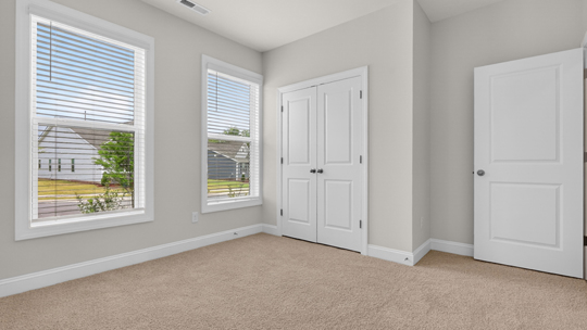 additional bedroom with window, carpeting, closet