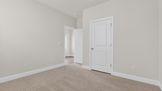 secondary bedroom with window and closet, carpeting