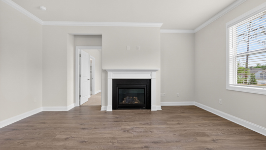 open concept living space with large windows, fireplace