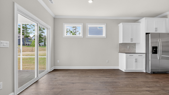 open concept dining space with door to patio