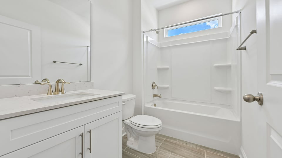 secondary bathroom with shower tub combo and single vanity sink