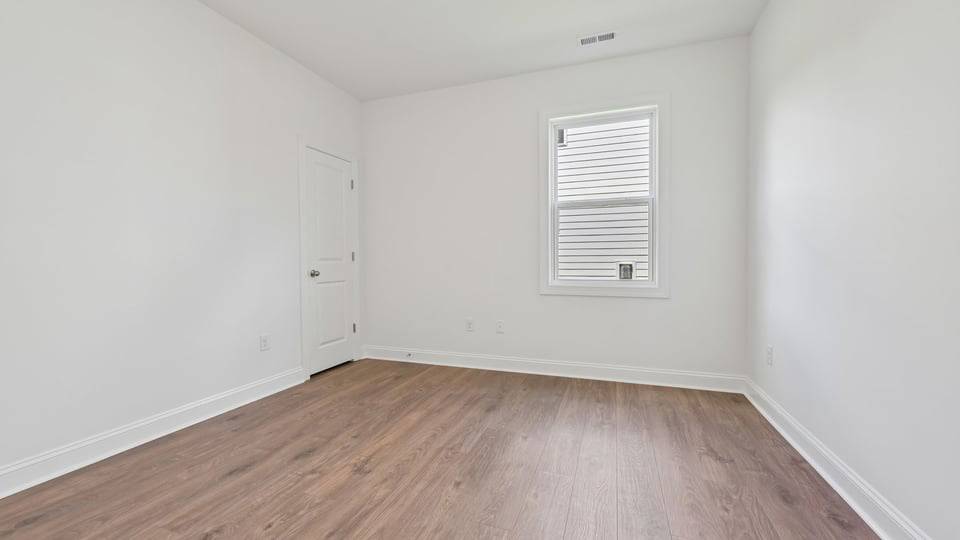 additional bedroom with window, carpeting, closet