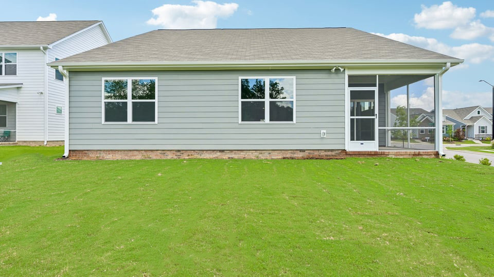 back exterior with enclosed patio  and yard