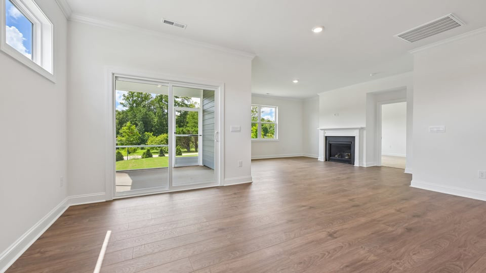 open concept living space with large windows, fireplace