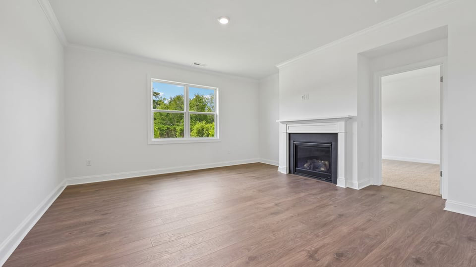 open concept living space with large windows, fireplace