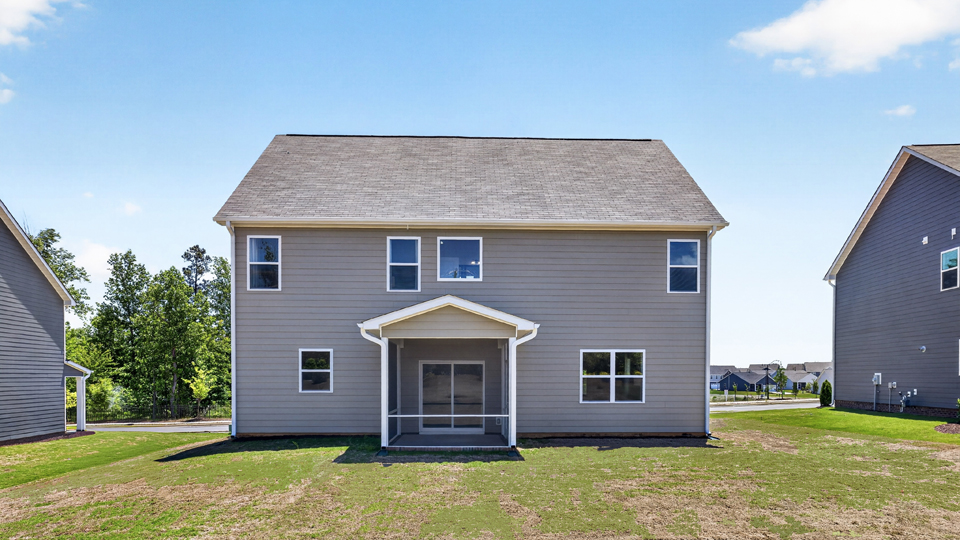Lucas H back exterior with large yard and enclosed patio