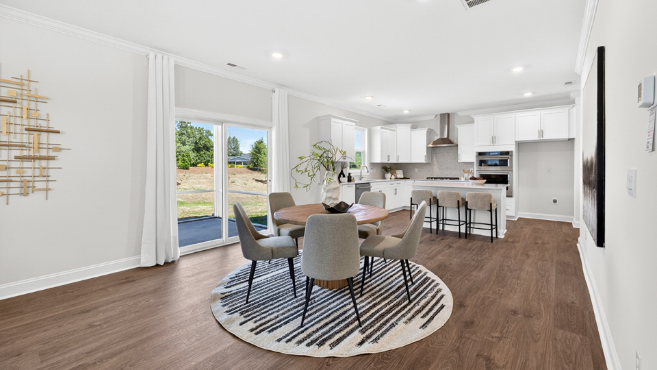 open concept dining space with door to patio