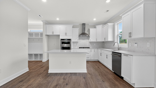 kitchen with island quartz countertops and white cabinets