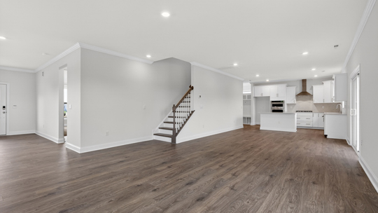 kitchen overlooking dining area and living room with revwood flooring