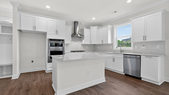 kitchen with island quartz countertops and white cabinets