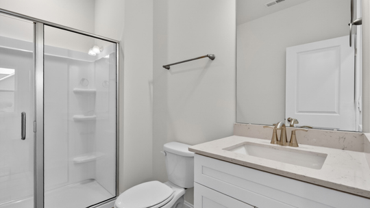 bathroom with walkin shower and quartz countertops