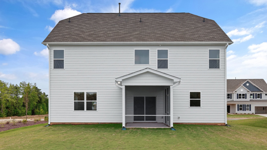 back of home with covered and screened in patio