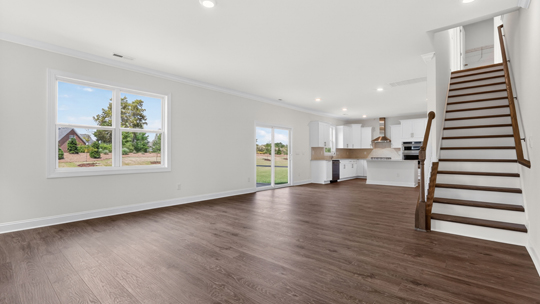 open concept living area and bottom of stairs
