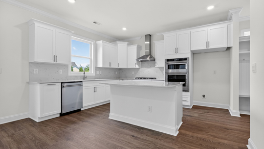 kitchen with island white cabinets and quartz countertops