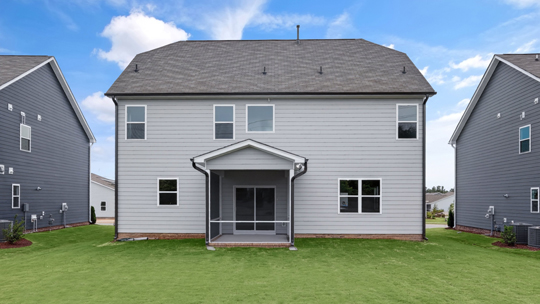 back of home with covered and screened in patio
