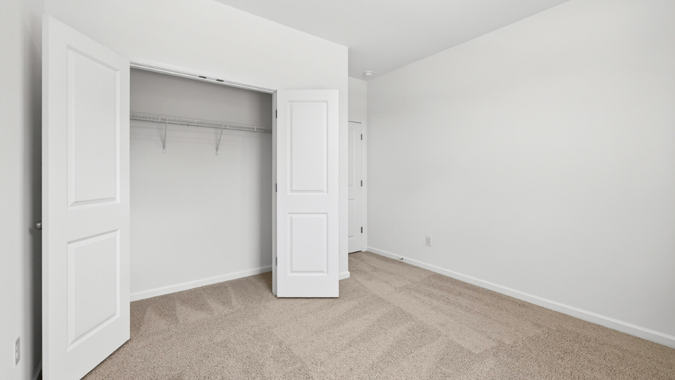 additional bedroom with window, carpeting, closet