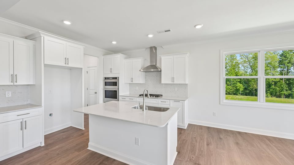 gourmet kitchen with island white cabinets and quartz countertops