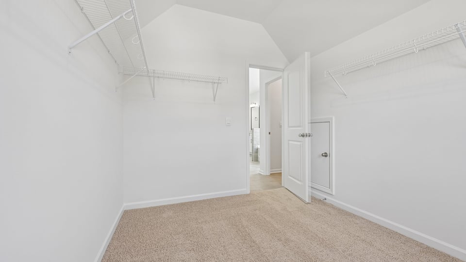 walkin closet with wire shelving and window