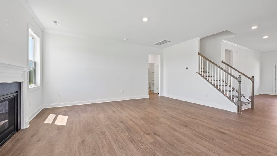 living room with revwood flooring and fireplace