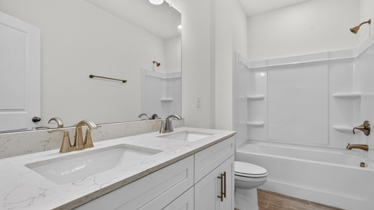 bathroom with quartz countertops and tub shower combo