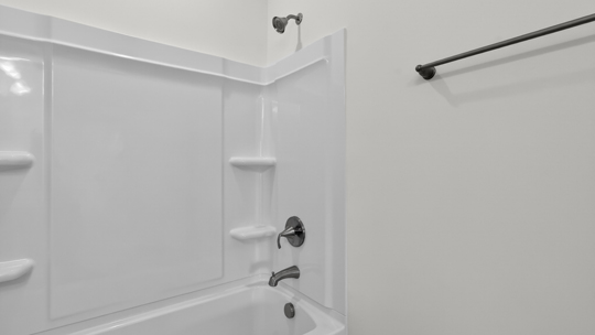 bathroom with tub shower comnbo
