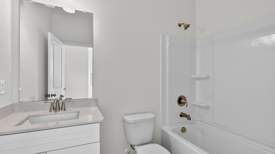 bathroom with tub shower comnbo