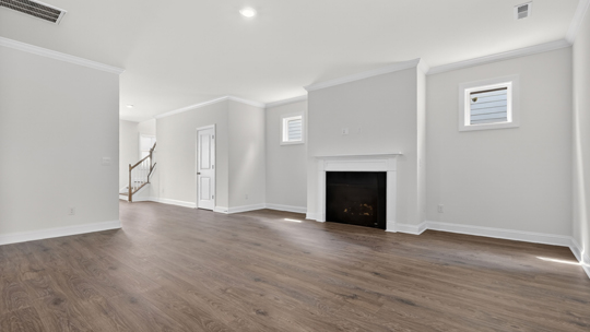 living room with revwood flooring and fireplace