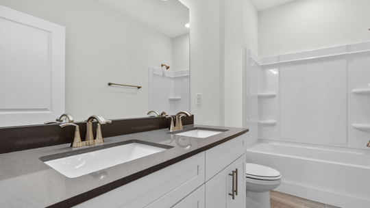 bathroom with quartz countertops and tub shower combo
