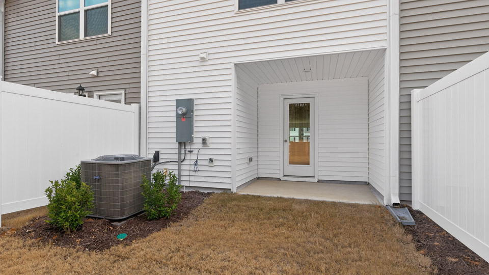 Two story town home with white siding.