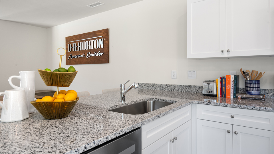 kitchen with stainless steel appliances, granite countertops and vinyl flooring