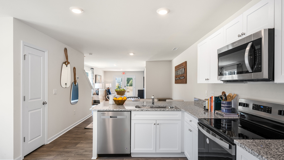 kitchen with stainless steel appliances, granite countertops and vinyl flooring
