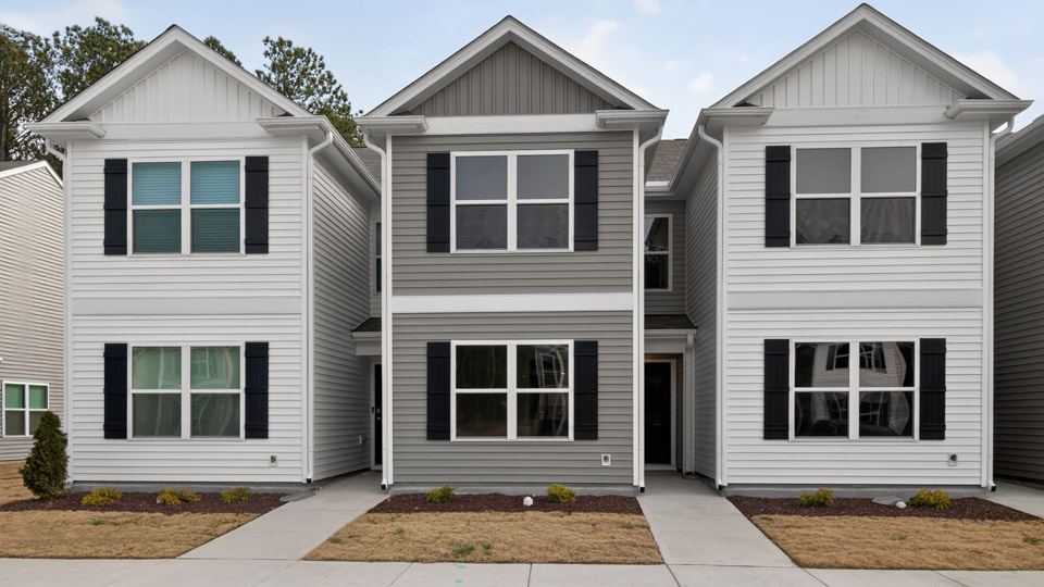 Two story town home with gray siding.