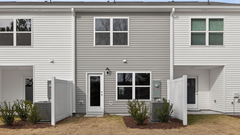 Two story town home with gray siding.
