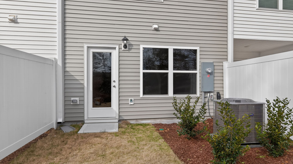 Two story town home with gray siding.
