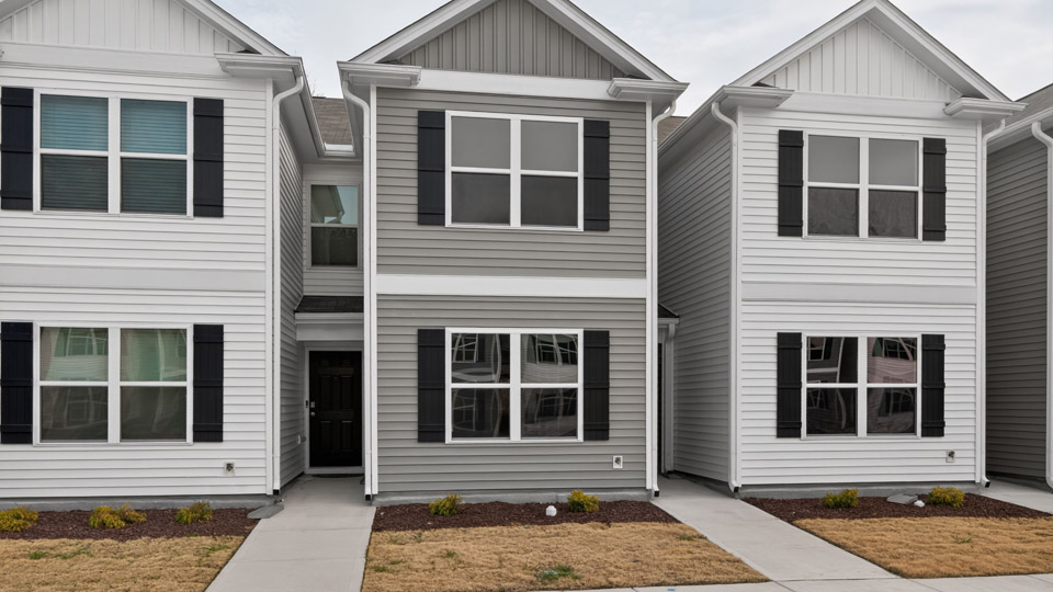 Two story town home with gray siding.