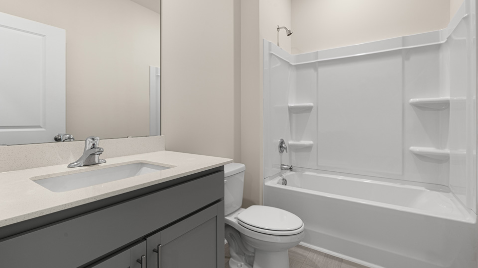 secondary bathroom with shower tub combo and single vanity sink